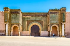 The grand entrance to Marrakech, showcasing intricate architecture and vibrant colors, welcoming visitors to the city.